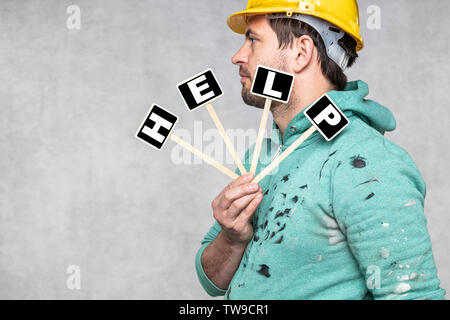 construction worker holding a blackboard with space for text or text, copy space, Stock Photo