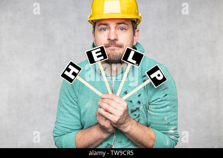 construction worker holding a blackboard with space for text or text, copy space, Stock Photo