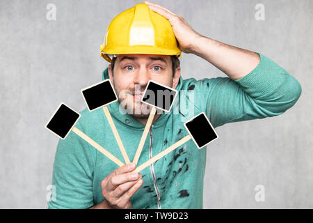 construction worker holding a blackboard with space for text or text, copy space, Stock Photo
