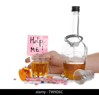 Man in handcuffs holding note with words 'Help me' near alcohol, cigarettes and drugs on white background Stock Photo
