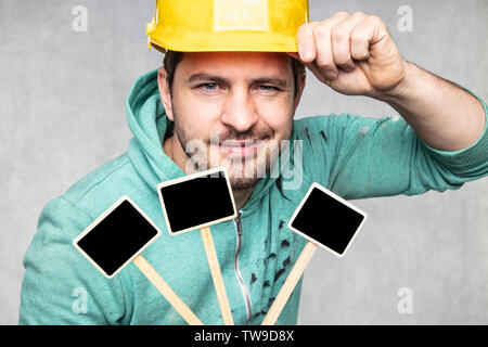 construction worker holding a blackboard with space for text or text, copy space Stock Photo