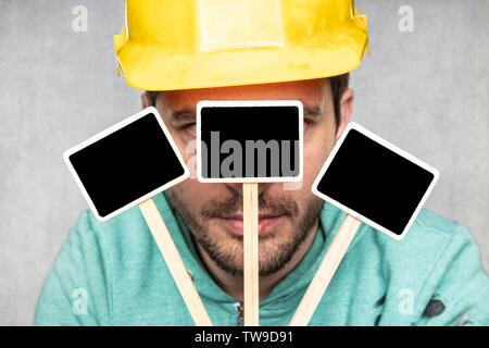 construction worker holding a blackboard with space for text or text, copy space Stock Photo