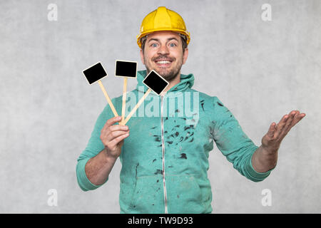construction worker holding a blackboard with space for text or text, copy space Stock Photo