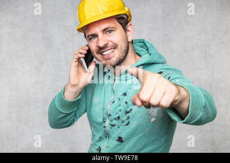 the building investor is talking on the phone and pointing to you Stock Photo