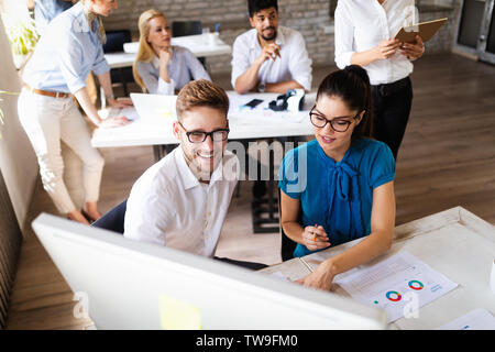 Group of business professionals having a meeting. Diverse group of designers smiling at the office. Stock Photo