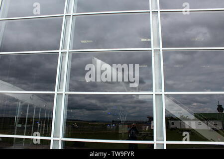 Families visiting Manchester airport's runway visitor park watching the aircraft come and go Stock Photo