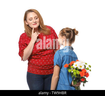 Cute girl hiding flowers for mother behind her back on white background Stock Photo