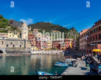 Frontal view of the harbour, marina and main square of the town of Vernazza in Cinque Terre Region. Vernazza, Italy - April 20, 2019 Stock Photo