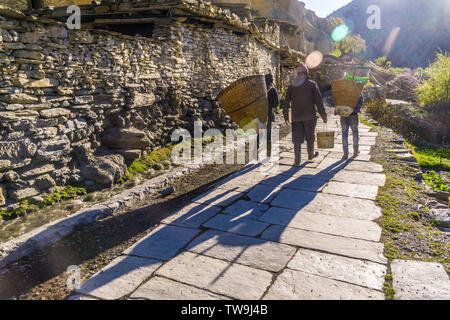 The Tibetian village of Marpha in the Lower Mustang Valley, Nepal.   Marpha means 'hard-working people' and the picture shows a family off to work Stock Photo