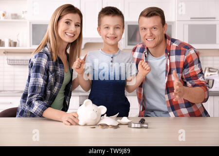 Happy family with broken piggy bank at home Stock Photo