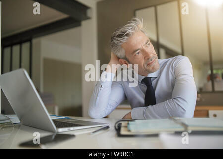 Handsome businessman in office taking a break Stock Photo