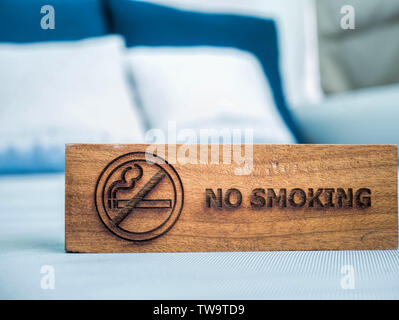 no smoking sign on the white sheet bed in hotel room Stock Photo