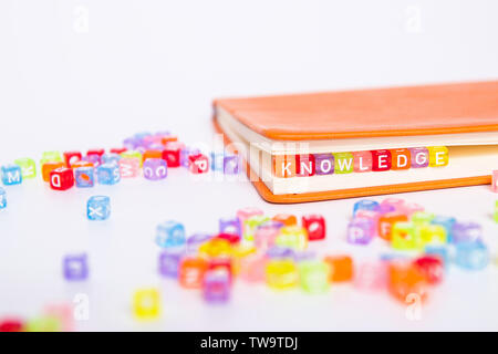 KNOWLEDGE word on colorful bead block as bookmark in book. education and knowledge concept Stock Photo