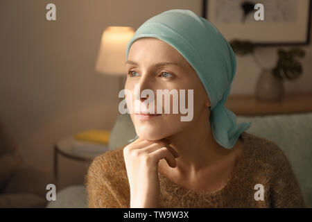 Young woman with cancer in headscarf indoors Stock Photo