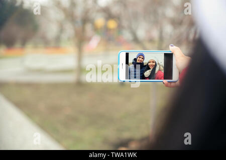 Cute couple taking selfie outdoors Stock Photo