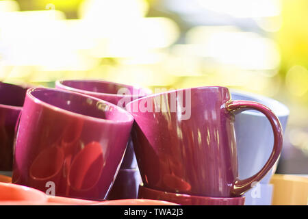 Many colorful empty ceramic cups in the store, Mugs background Stock Photo