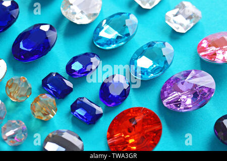 Different precious stones for jewellery on color background Stock Photo