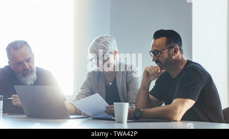 Group of business people meeting in conference room. Team of corporate professionals discussing new project. Stock Photo