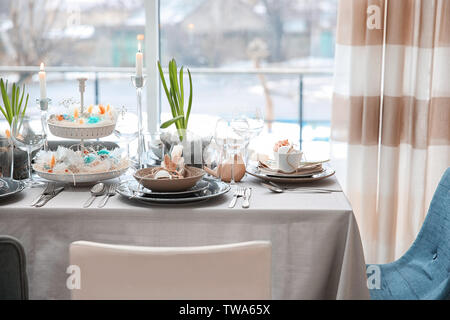 Beautiful Easter table setting with decorations Stock Photo