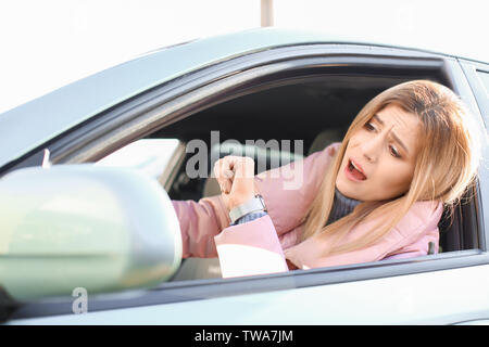 Emotional woman inside car in traffic jam Stock Photo