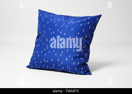 Soft decorative pillow on light background Stock Photo