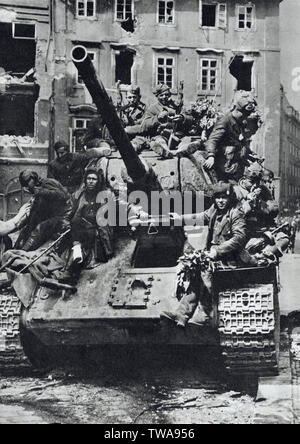 Red Army tank T-34 in Prague, Czechoslovakia, in May 1945. Black and white photograph by Czech photographer J.Krabičková published in the Czechoslovak book 'For the Eternal Times' ('Na věčné časy') issued in 1959. Courtesy of the Azoor Photo Collection. Stock Photo