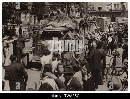 Red Army soldiers arrive to Pardubice in Czechoslovakia in May 1945. Black and white photograph by Czech photographer Jetřich Hemský published in the Czechoslovak vintage postcard issued in 1955. Soviet truck ZIS-5 produced by the Moscow ZIS Factory is pictured in the photograph. Courtesy of the Azoor Postcard Collection. Stock Photo