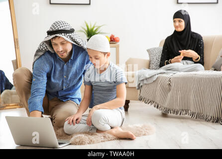 Happy Muslim family spending time together at home Stock Photo