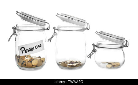 Glass jars with coins and tag PENSION on white background Stock Photo