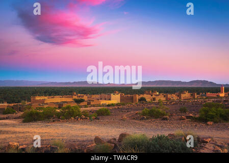 Sunset above a moroccan village with Atlas mountains in the background Stock Photo