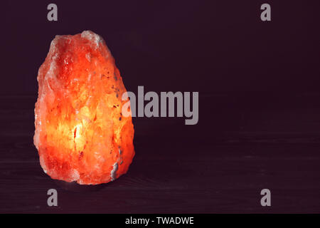 Himalayan salt lamp on black background Stock Photo