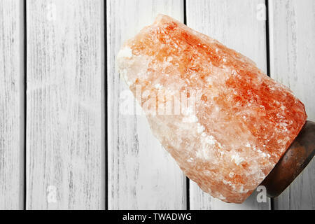 Himalayan salt lamp on wooden background Stock Photo