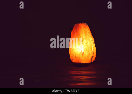 Himalayan salt lamp on black background Stock Photo