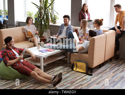Students resting together in campus building Stock Photo