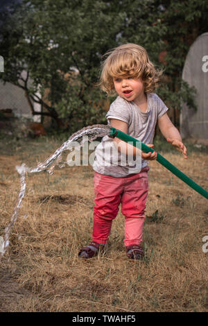 Adorable Little Girl Playing with Water Gun on Hot Summer Day. Cute Child  Having Fun with Water Outdoors Stock Photo - Image of leisure, beautiful:  97180460