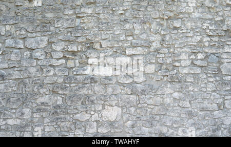 Old stone wall made of gray natural stones Stock Photo