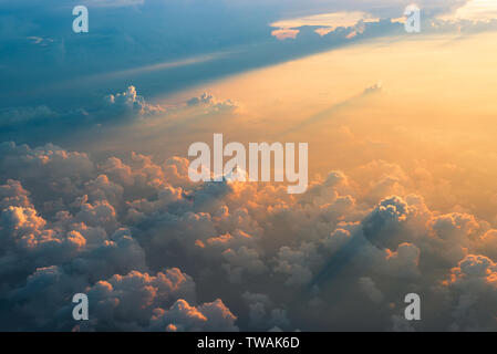 Beautiful aerial view of clouds at sunset, some clouds projecting dramatic shadows. View from airplane. Stock Photo