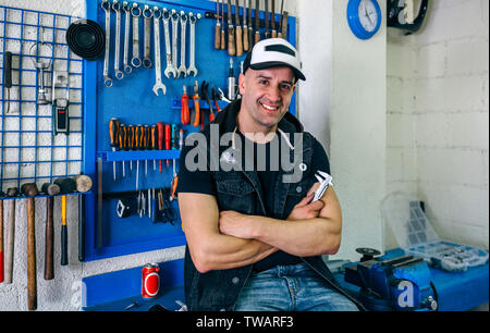 Mechanic posing with a motorcycle Stock Photo