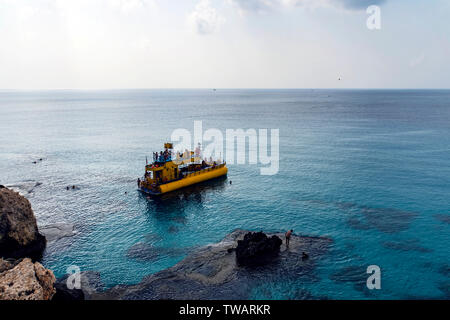 Pleasure boats moored in Ayia Napa near beach. Resort town at the far eastern end of the southern coast of Cyprus island Stock Photo