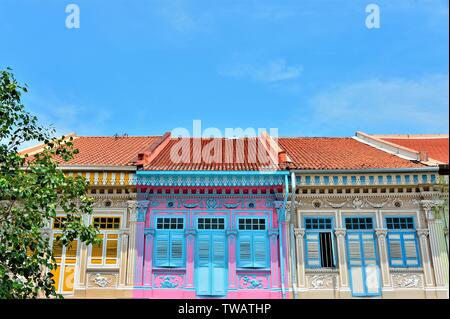 Front view of colourful traditional Singapore Peranakan or Straits Chinese shophouse in historic Joo Chiat East Coast against blue sky Stock Photo