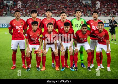 Players of the starting line-up of China's Guangzhou Evergrande Taobao F.C. pose for photos before competing against China's Shandong Luneng Taishan F.C. in the eighth-final match during the 2019 AFC Champions League in Guangzhou city, south China's Guangdong province, 18 June 2019. Thanks to Yang Liyu's lucky winner, Guangzhou Evergrande beat Shandong Luneng 2-1 in the first leg of AFC Champions League knock-out Round 1 here on Tuesday. Stock Photo