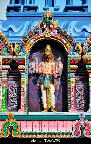 Colourful statues of Hindu religious deities adorning the entrance of famous Hindu temple in Little India, Singapore in close up Stock Photo