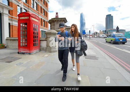 London, England, UK. Young couple walking across Blackfriars Bridge Stock Photo