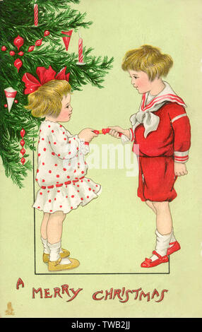 Brother and Sister pulling a Christmas Cracker by the Tree Stock Photo