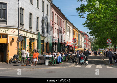 Oslo cafe, view in summer of Norwegian people relaxing at tables outside cafes and bars along Gruners Gate in the Grunerlokka area of Oslo, Norway. Stock Photo