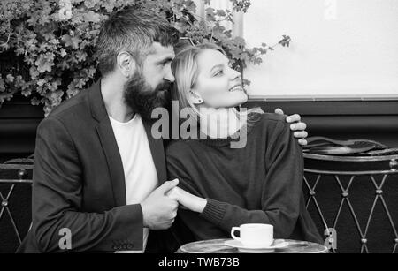 Couple cuddling cafe terrace. Couple in love sit cafe terrace enjoy coffee. Pleasant family weekend. Married lovely couple relaxing together. Travel and vacation. Explore cafe and public places. Stock Photo