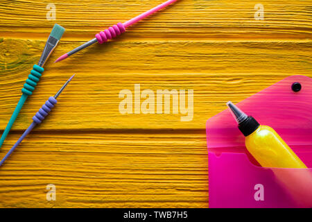 Back to school supplies arrangement vivid colorful neon color on yellow Stock Photo