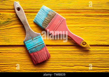Coral color and yellow vivid grunge brushes on aged painted wood Stock Photo