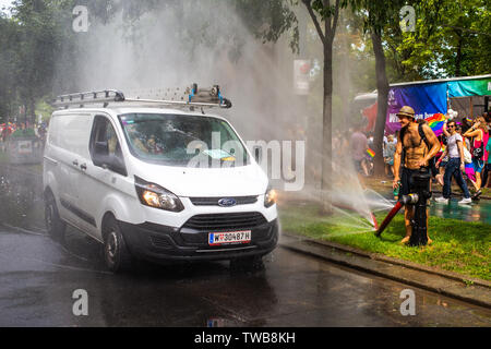 A white van passes a spraying jet of water at Euro Pride, the largest Pride event in Europe. Vienna 15 June 2019 Stock Photo