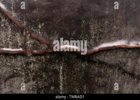 Crumpled and scratched steel and copper metal texture. Abstract background. Stock Photo